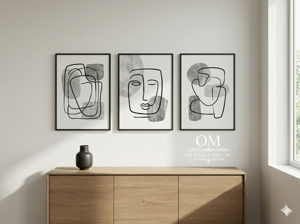 Triptych of monochromatic abstract art frames on an off-white wall in a modern office, showcasing contemporary Wall Decor India trends